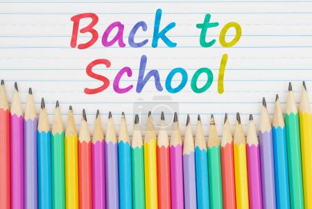 Photo for Back to School message with color pencils on vintage ruled line notebook paper for you education or school message - Royalty Free Image