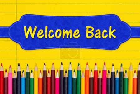 Photo for Welcome back message with color pencils crayons on vintage yellow ruled line notebook paper - Royalty Free Image