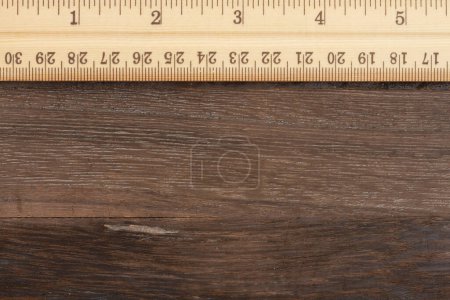 Photo for Wood ruler with brown weathered grained textured material wood background - Royalty Free Image
