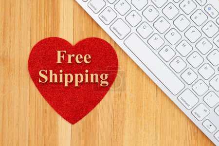 Photo for Free shipping for online shopping with a keyboard and heart on a wood desk - Royalty Free Image