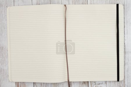 Photo for Ruled line journal paper page notepad background on weathered desk for writing or journaling - Royalty Free Image