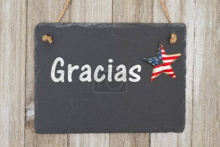 Photo for A rustic Spanish patriotic thank you message, A retro chalkboard with a vintage USA star hanging on weathered wood background with text Gracias - Royalty Free Image