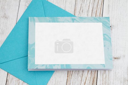 Téléchargez les photos : Carte de vœux vierge avec enveloppe bleue sur bois altéré - en image libre de droit