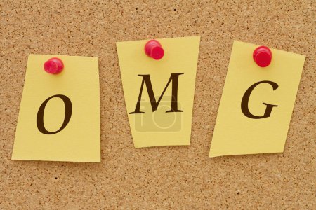 Foto de OMG, tres notas amarillas en un tablero de corcho con la palabra OMG - Imagen libre de derechos