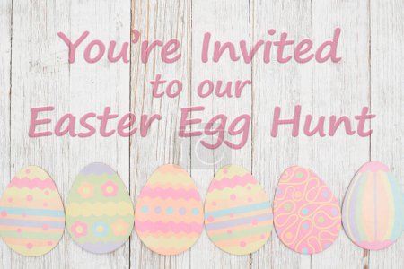 Photo for Easter egg hunt invitation with Easter eggs on weathered wood - Royalty Free Image