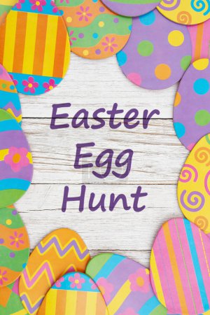 Photo for Easter egg hunt invitation with Easter eggs on weathered wood - Royalty Free Image