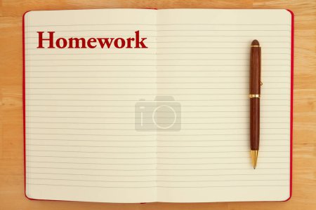 Photo for Homework message on lined rule paper notebook with a pen - Royalty Free Image