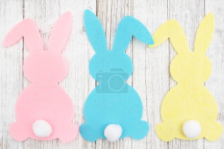 Pink Easter bunny rabbit background on weathered wood