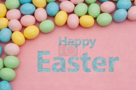 Photo for Happy Easter greeting with pale Easter egg on pink felt - Royalty Free Image