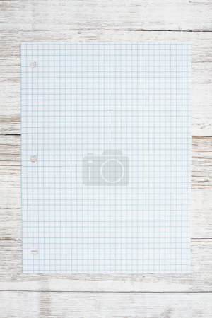 Photo for Ruled lined graph paper for school on weathered wood desk - Royalty Free Image