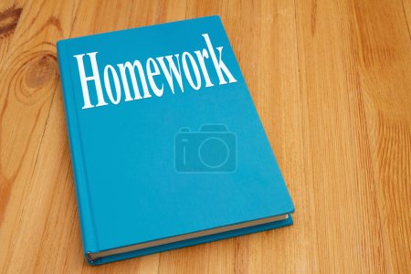 Photo for Homework for a course on retro old blue book on weathered desk for reading for school - Royalty Free Image