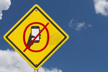 No texting or cell phone while driving on warning road sign with sky