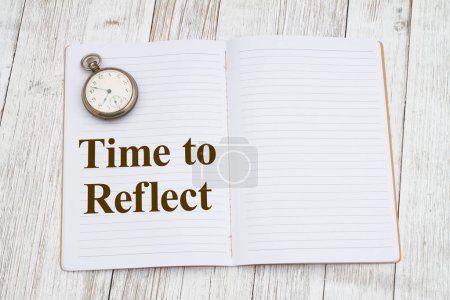 Photo for Time to reflect with a ruled line journal paper page notepad with pocket watch on weathered desk for writing or journaling - Royalty Free Image