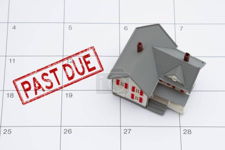 Photo for Mortgage payment due with house and red past due stamp on a calendar - Royalty Free Image