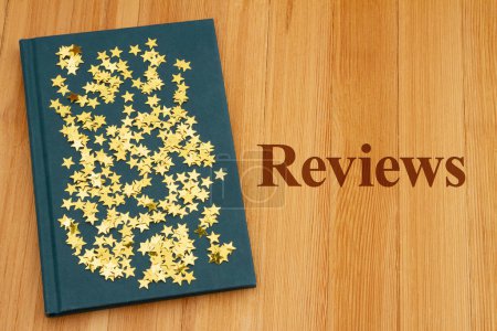 Photo for Book Reviews with retro old blue book with stars on weathered desk for reading or school - Royalty Free Image