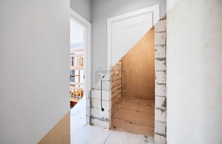 Old apartment with brick walls and new renovated flat doors, room and elegant interior design. Comparison of apartment before and after restoration. Home renovation concept.