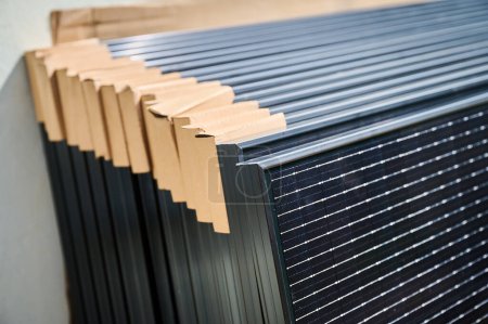 Téléchargez les photos : Décryptages nouveaux panneaux solaires avec coins en carton de protection, prêts à être installés. Technologies des énergies renouvelables, mode de vie vert et mise en œuvre de l'énergie solaire dans les zones résidentielles. - en image libre de droit