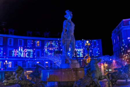 Nice, France - December 28, 2021 Blue Apollo Statue Sun Fountain Plaza Massena Christmas Decorations Cityscape Nice Cote d'Azur France Statue by Alfred Janniot in 1956