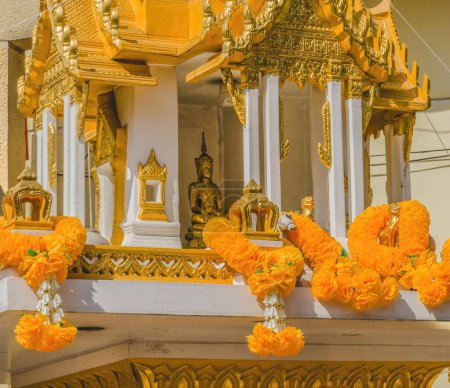 Photo for Golden Yellow Spirit House Buddha Shrine Marigold Garlands Yodpiman Pak Khlong Talat Flower Market Bangkok Thailand. Shrine to the protective guardian spirit of place - Royalty Free Image