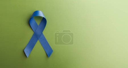 Photo for Prostate Cancer Awareness Campaign Concept. Men Healthcare. Close up of a Blue Ribbon Lying on Green background, Top View - Royalty Free Image