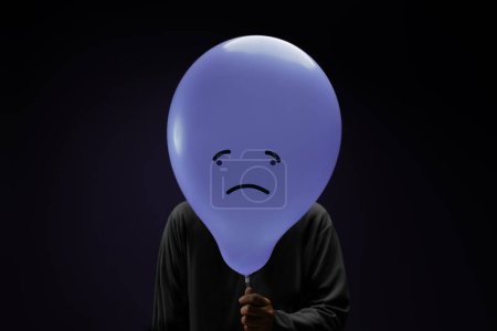 Photo for Mental Health Concept. a Stressed, Anxiety, Depressed Person with a Balloon, Negative Emotion and Feeling. Moody. Dark tone - Royalty Free Image
