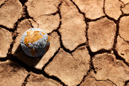 Photo for Water Crisis, Climate Change, El Nino, Global Warming Issue Concept. Brown Globe lay on Cracked Dry Soil Ground. Land without Water. High Temperature on Hot Sunny Day - Royalty Free Image