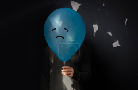 Photo for Mental Health Concept. a Stressed, Anxiety, Depressed Person with a Balloon, Negative Emotion and Feeling. Moody. Dark tone - Royalty Free Image