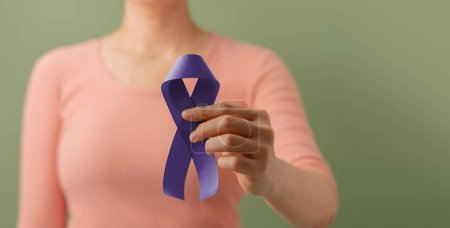 Photo for Cancer Awareness Campaign Concept. Global Healthcare. World Cancer Day. Close up of a Young Female Brings a Violet Ribbon into the Front. - Royalty Free Image
