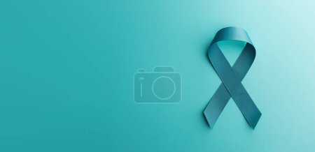 Photo for Ovarian and Cervical Cancer Awareness. a Teal Ribbonin Top View position, Uterus, Female Reproductive System, Women's Health, PCOS and Gynecology - Royalty Free Image