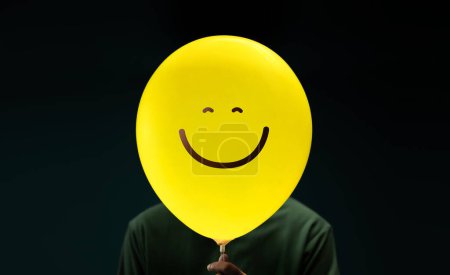 Photo for Happiness Day Concept. Happy and Optimistic Mind, Well Mental Health. Enjoying Life Everyday. Happiness Person with a Smiling Emoticon Balloon - Royalty Free Image