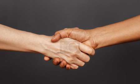Photo for Close Up of Two People Shaking Hand together. Sign of Human Cooperation ,Agreement, Congratulations, Mergers and Acquisitions. Greeting or Finishing up Meeting. Handshaking with Great Deal. - Royalty Free Image