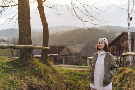 Photo for Girl hiker on vacation starting hike on the slopes in the mountains of the Carpathians. Portrait of a beautiful woman going for a walk in the mountains. - Royalty Free Image