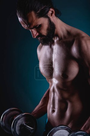Photo for Powerful muscular man lifting weights. Beautiful masculine bearded young hipster man holding dumbbells. - Royalty Free Image