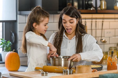 Photo for Mother and daughter baking pie together - Royalty Free Image