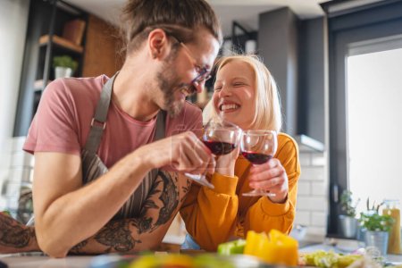 Photo for Beautiful young hipster love couple toasting with wine at home - Royalty Free Image