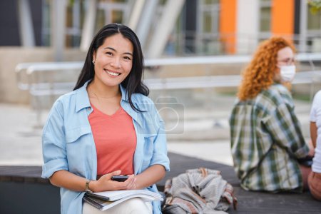 Photo for Smiling young female students in campus - Royalty Free Image