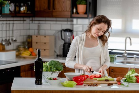 Téléchargez les photos : Jeune femme enceinte préparant des aliments sains avec des fruits et légumes - en image libre de droit