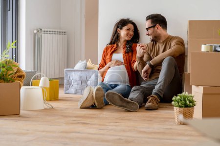 Photo for Young couple, future parents in new flat - Royalty Free Image