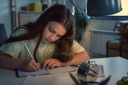 Photo for Close up portrait of little girl studying at home - Royalty Free Image