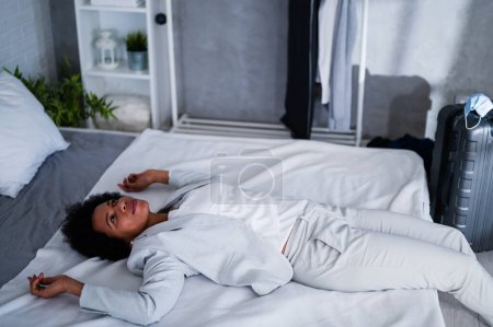 Photo for Black woman traveler, exhausted from a trip taking a nap - Royalty Free Image