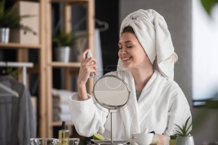 Photo for Portrait of a young beautiful woman wearing a bathrobe at home. doing her daily skincare routine with natural cosmetics - Royalty Free Image