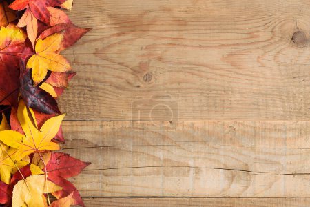 Photo for Autumn background with colorful leaves on the rustic wooden top with copy-space - Royalty Free Image