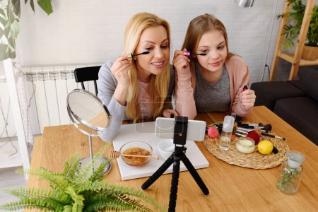 Photo for Mother and daughter bloggers recording video for blog - Royalty Free Image