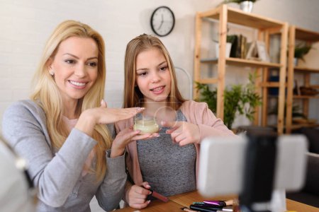 Photo for Mother and daughter bloggers recording video for blog - Royalty Free Image