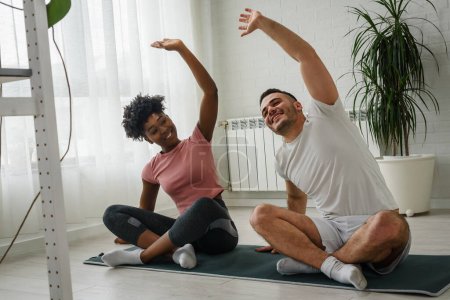 Photo for Fit couple doing exercises at home healthy lifestyle - Royalty Free Image