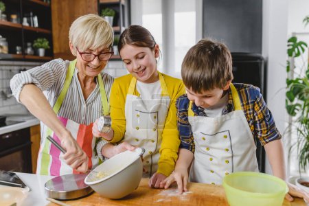 Téléchargez les photos : Mamie avec petits-enfants préparation de biscuits - en image libre de droit