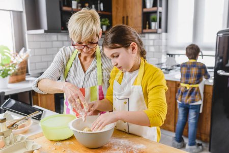 Photo for Granny with grandchildren preparing cookies - Royalty Free Image