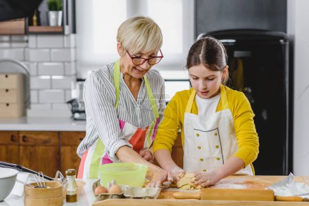 Photo for Granny with granddaughter making cookies - Royalty Free Image