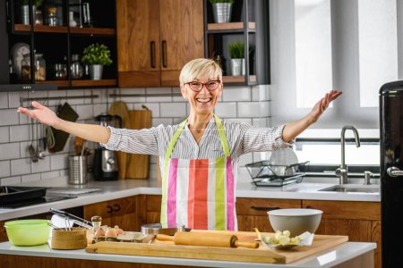 Photo for Senior woman food blogger filming recipe - Royalty Free Image