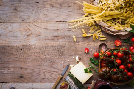 Photo for Ingredients for tomato pasta on wooden table - Royalty Free Image